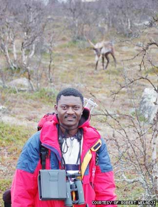 Robert Weladji in northern Europe is flanked by a single reindeer.
